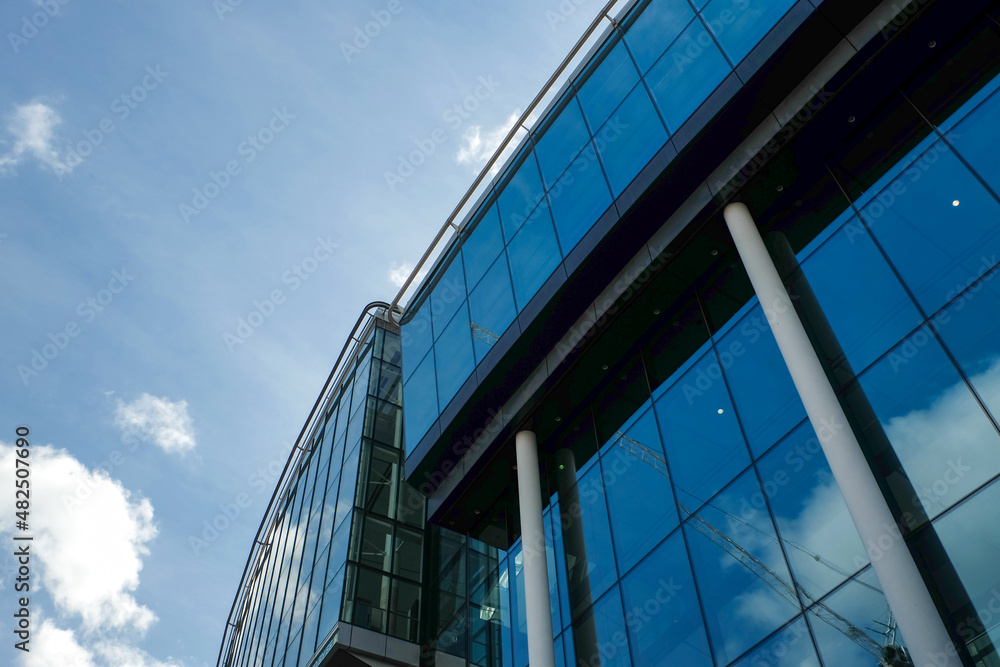 A low angle picture of under renovation building full with glass in London, United Kingdom. A low angle picture of under renovation building full with glass in London, United Kingdom.