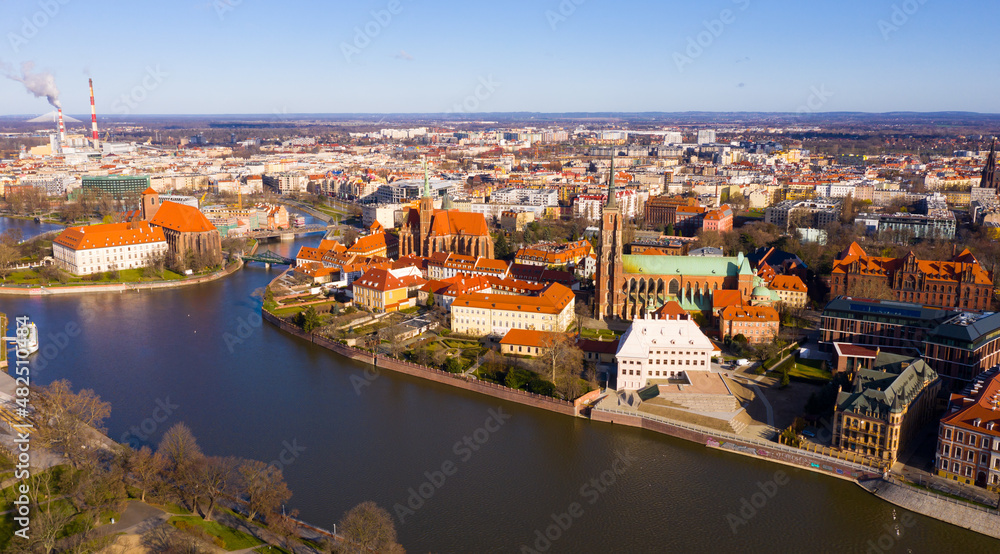 Scenic view from drone of Gothic buildings of Cathedral of St. John Baptist and Collegiate Church of Holy Cross and St. Bartholomew on Ostrow Tumski on sunny day, Wroclaw, Poland..
