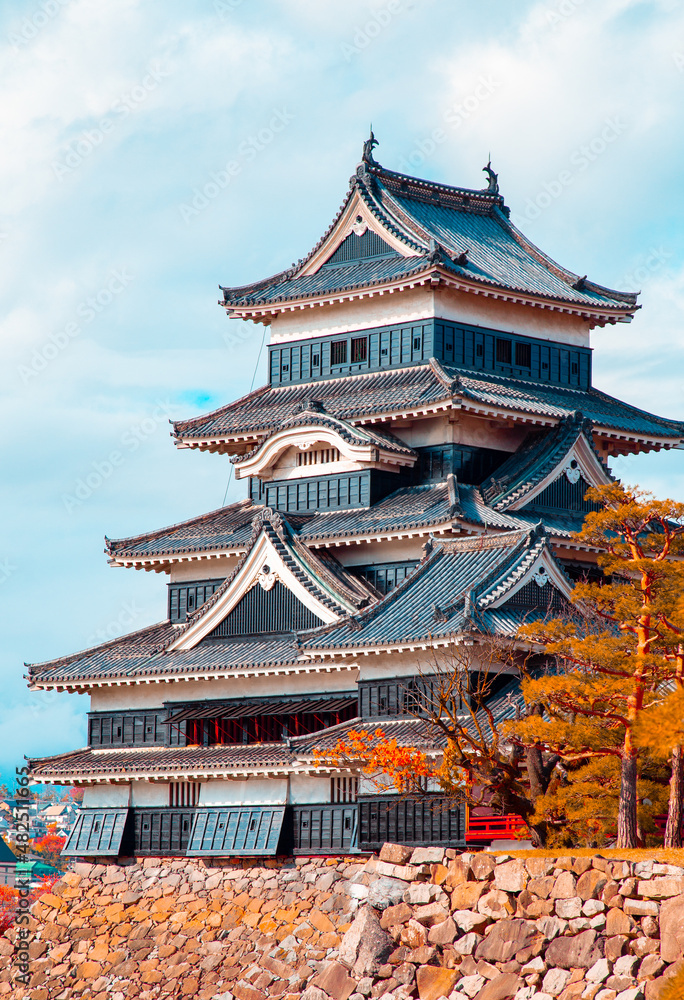 Vertical View of Matsumoto castle with blue skies in Japan Vertical View of Matsumoto castle with blue skies in Japan
