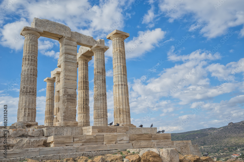 Close up view of Temple of Poseidon with blue sky and clouds, Sounion, Greece