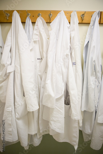 lab coats hanging in hallway