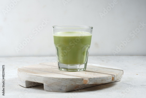 a glass of Japanese matcha latte, green tea with milk or soy milk, whitw background