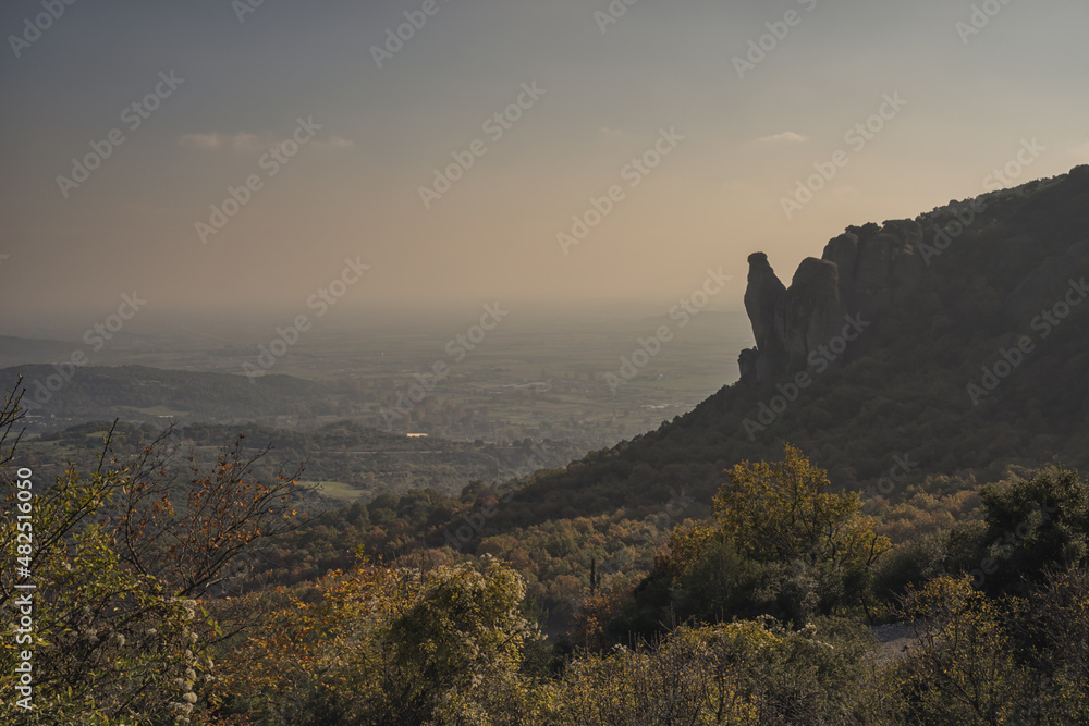 Hazy landscape of rock formations in Meteora, Greece