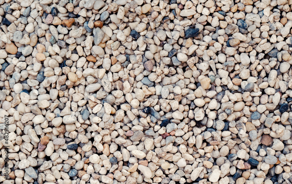 Natural background of small stones and pebbles on the ground for the garden decoration. Natural background of small stones and pebbles on the ground for the garden decoration.