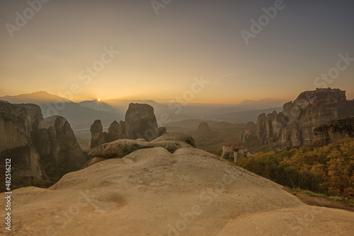 Sunset looking across the rock formations in Meteora with monastery in the distance  Greece