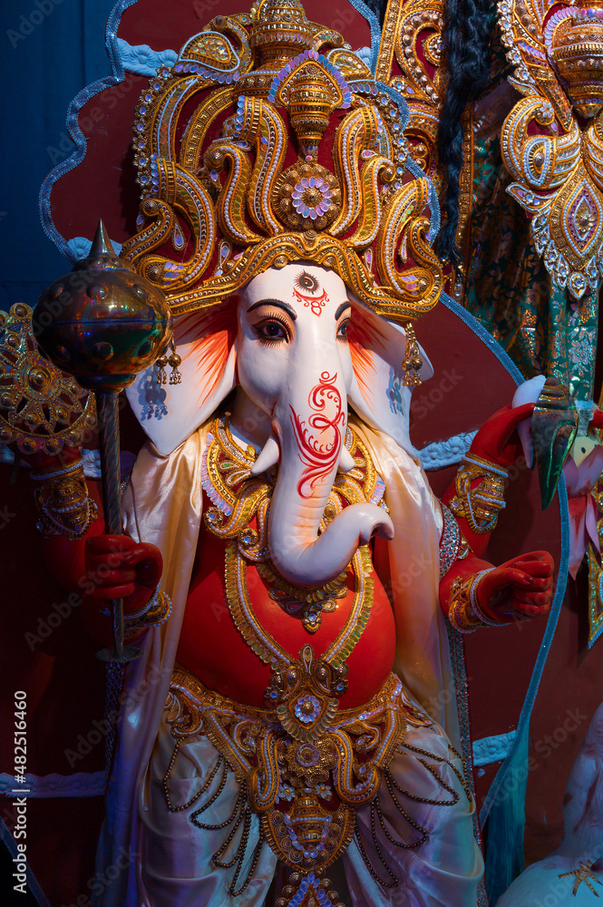 Idol of God Ganesha , Durga Puja festival at night. Shot under colored light at Howrah, West Bengal, India.