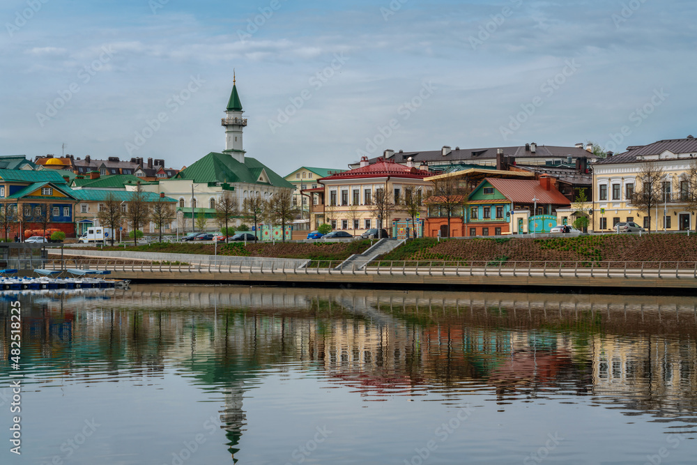 View of the embankment of Lake Nizhny Kaban, Shigabutdin Marjani Street with traditional Tatar mansions and Marjani Mosque on a spring day, Kazan, Republic of Tatarstan, Russia