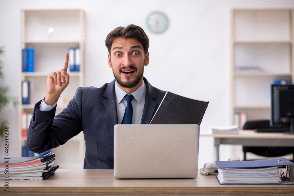 Young male employee working in the office Young male employee working in the office