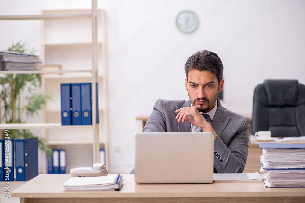 Young male employee working in the office Young male employee working in the office