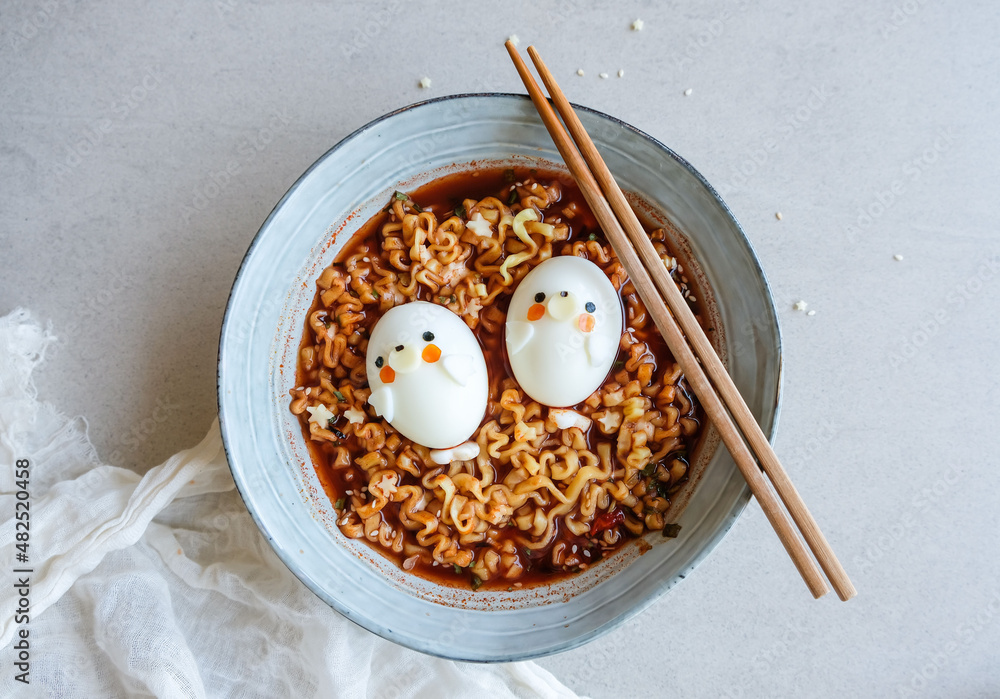 Fototapeta premium Homemade Korean cuisine. Korean Spcy Stew Noodles with Kimchi & Eggs. During the Covid-19 pandemic lockdown, best thing to do is stay home and cook more nutritious food for the family to eat