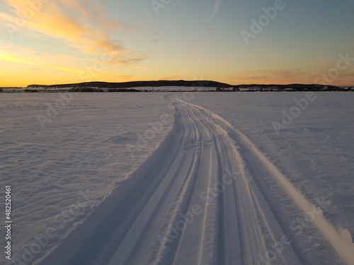 Snowmobile trail in a snowy field