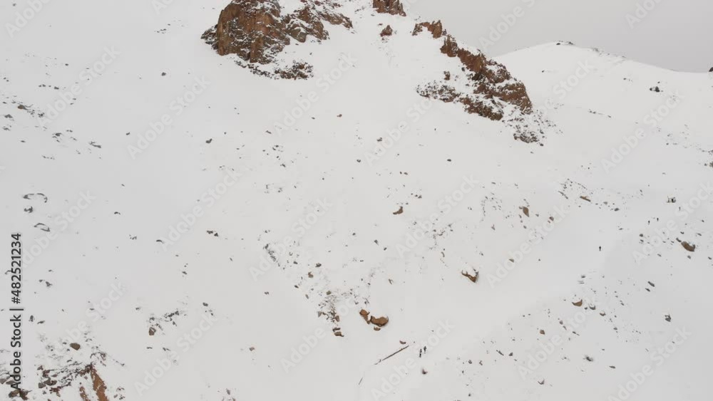 Aerial shot of man in winter mountains Aerial shot of man in winter mountains