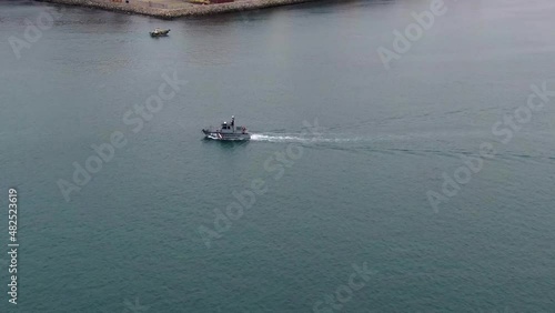 Peruvian Coastguard Patrol Vessel Navigating Across The Callao Harbor In Lima, Peru. aerial photo