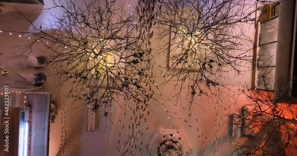 custom made wallpaper toronto digitalFootprints in snow at night. Walking path between buildings decorated with Christmas lights in fresh snowfall.