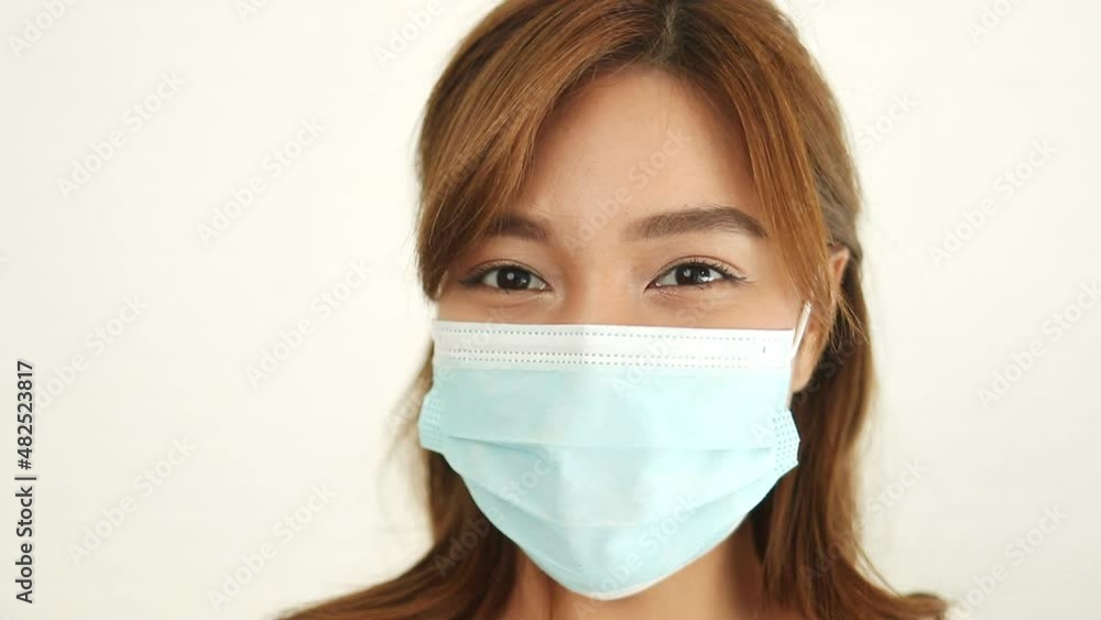Asian long haired beautiful woman Wear a protective mask against the coronavirus (COVID-19) and flu. The concept of health care to reduce the transmission of infection. Asian long haired beautiful woman Wear a protective mask against the coronavirus (COVID-19) and flu. The concept of health care to reduce the transmission of infection.
