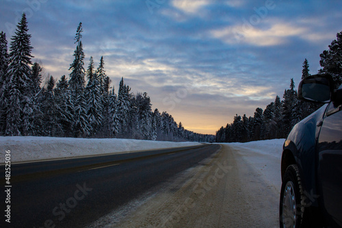 A section of the Khanty-Mansiysk - Nyagan highway in Russia. Track in the morning in winter at dawn in Siberia in frost. photo