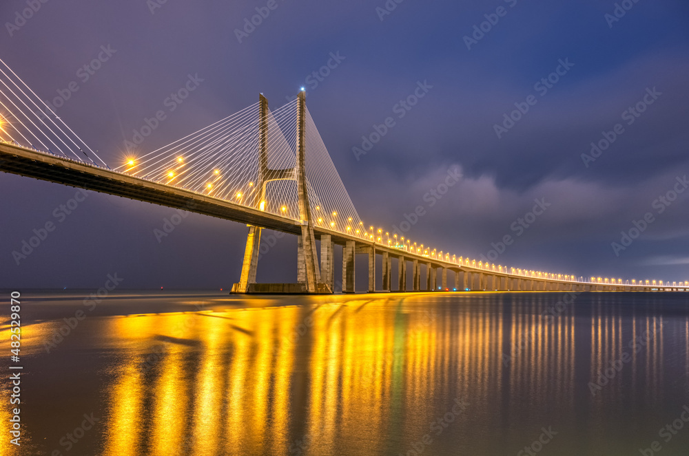 The famous cable-stayed Vasco da Gama bridge across the river Tagus in Lisbon, Portugal, at night