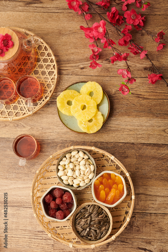 Bowls with nuts, seeds and candied fruits to eat with tea on Chinese New Yeer Bowls with nuts, seeds and candied fruits to eat with tea on Chinese New Yeer