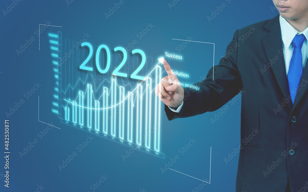 A business man poke his finger on a graph on a virtual screen.Success in business and achieving financial goals.business concept A business man poke his finger on a graph on a virtual screen.Success in business and achieving financial goals.business concept