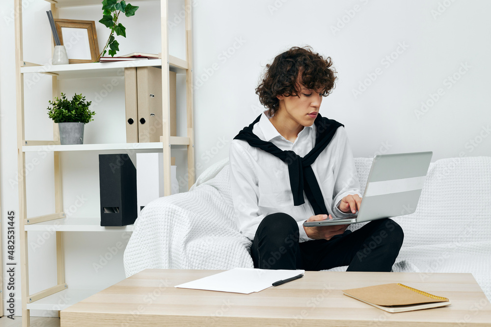 guy on a white sofa in front of a laptop learning living room guy on a white sofa in front of a laptop learning living room