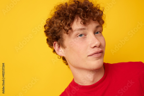 cute guy with curly hair in a red t-shirt close-up