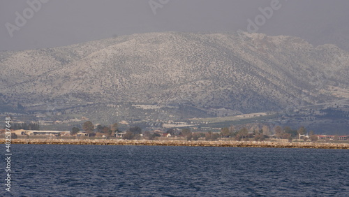 snow on mountains on Peloponnese, view from Nafplio on mountains, winter time in Greece, Europe