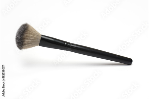 Closeup black cosmetic brush makeup white background