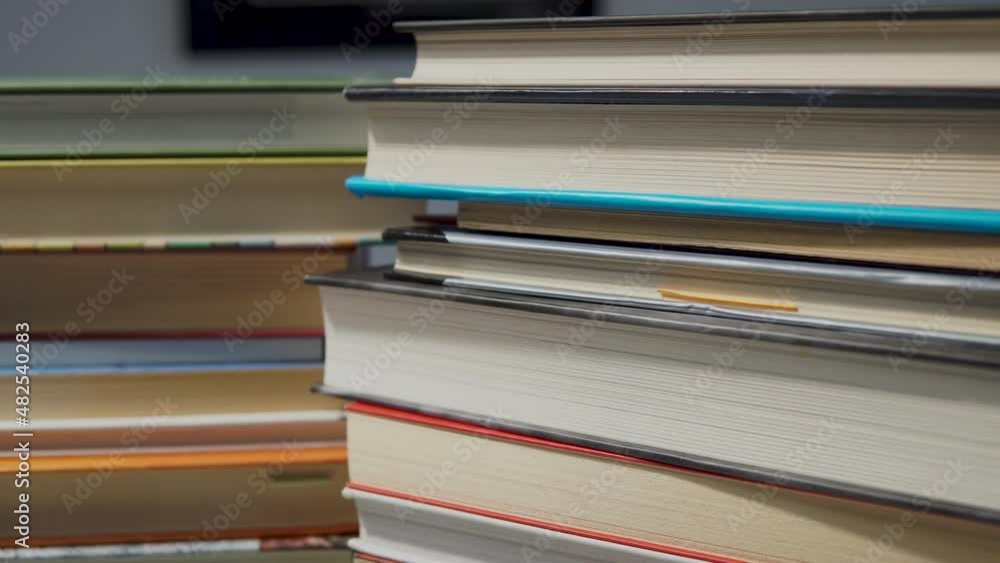 Piles Of Books On The Library Desk. Reading Concept. close up, panning right Piles Of Books On The Library Desk. Reading Concept. close up, panning right