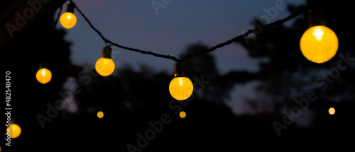 Yellow light bulb at twilight time