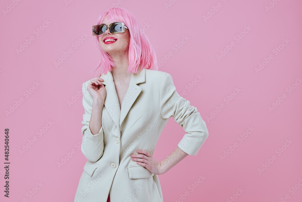 Young woman wearing sunglasses pink hair posing color background unaltered Young woman wearing sunglasses pink hair posing color background unaltered