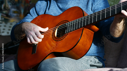 a man plays guitar at home