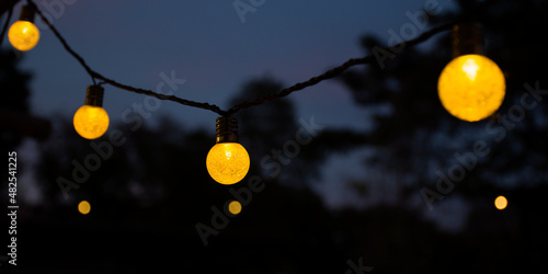 Fototapeta Naklejka Na Ścianę i Meble -  Yellow light bulb at twilight time