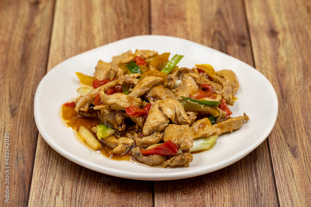 Chinese chicken dish. Chicken with olive oil and soy sauce. Traditional Chinese dish prepared with garlic, onion, capia pepper and green pepper Chinese chicken dish. Chicken with olive oil and soy sauce. Traditional Chinese dish prepared with garlic, onion, capia pepper and green pepper