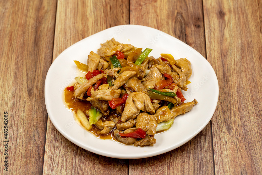 Chinese chicken dish. Chicken with olive oil and soy sauce. Traditional Chinese dish prepared with garlic, onion, capia pepper and green pepper