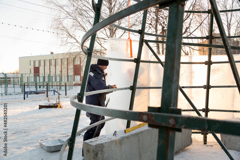 The fitter overlays the metal frame with ice blocks The fitter overlays the metal frame with ice blocks