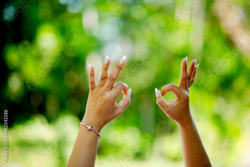 hand gesture ok girl doing okay gesture with her hands understanding of every opportunity that comes and goes © FOTO SALE