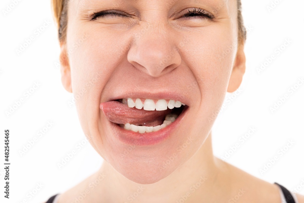 portrait of a young charismatic cheerful woman smiling and tongue coquettishly looking at the camera portrait of a young charismatic cheerful woman smiling and tongue coquettishly looking at the camera