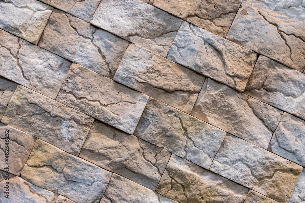 Fototapeta premium Decorative brown stone wall with a beautiful diagonal texture