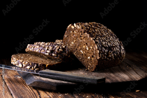 Rustic grain bread with sunflower seeds on a wooden board
