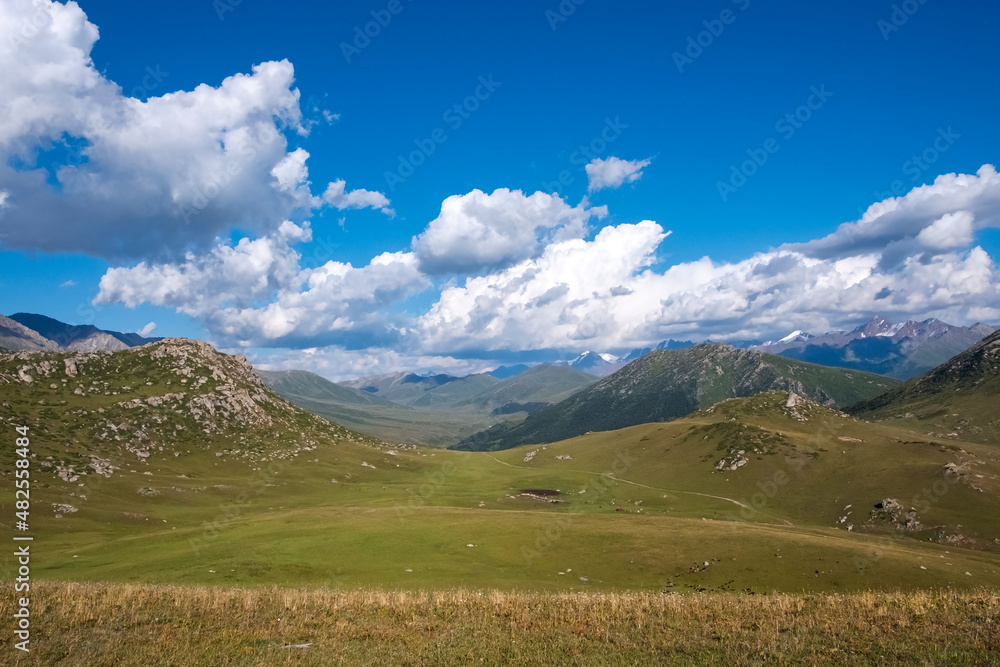 Beautiful mountain valley landscape with cloudy sky on background.