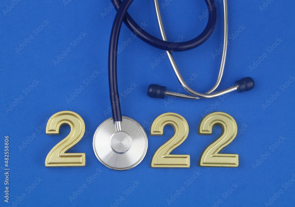 Stethoscope and numbers 2022 on wooden table. Health care in year 2022 concept. Stethoscope and numbers 2022 on wooden table. Health care in year 2022 concept.