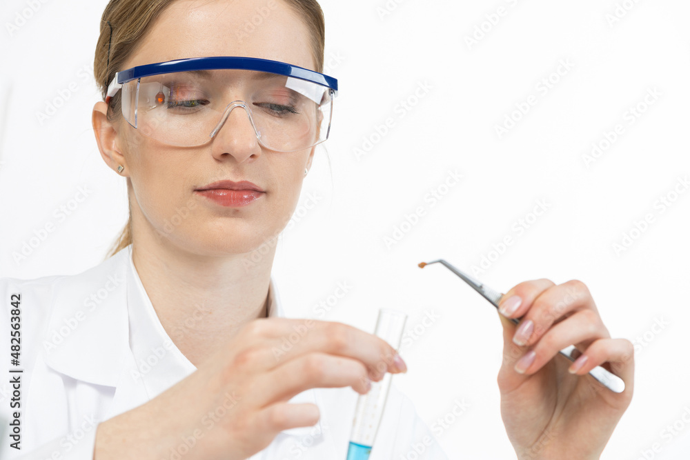 Young female research scientist puts sample Young female research scientist puts sample