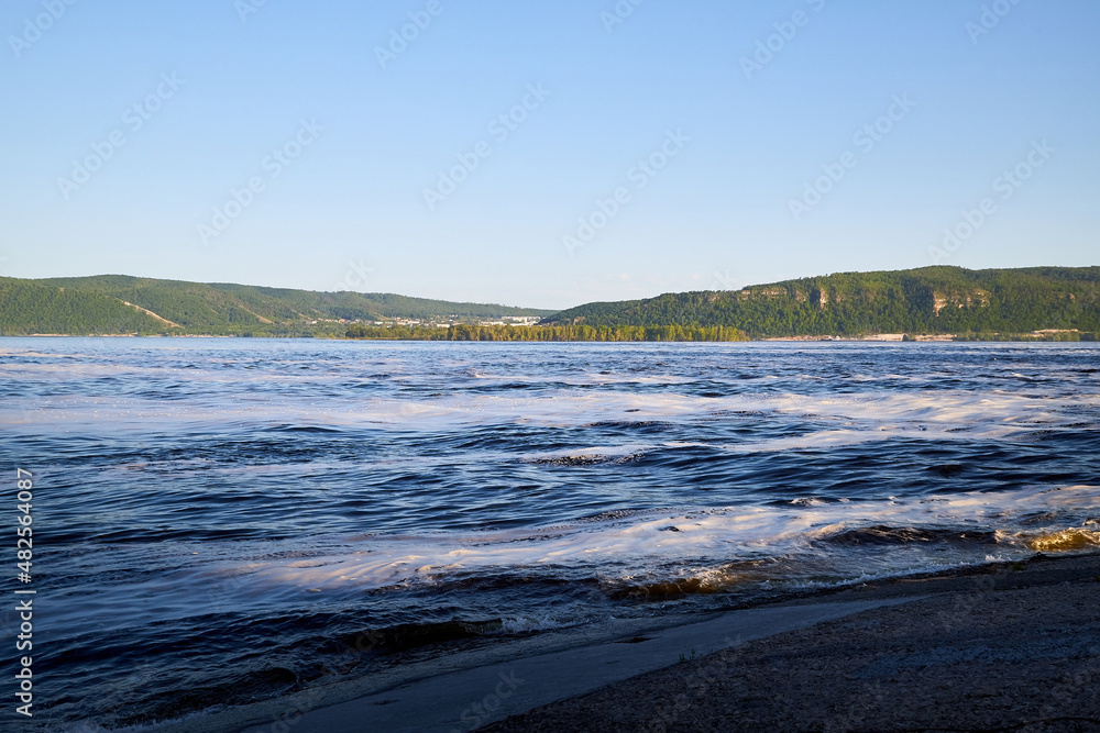 Obraz premium Nature landscape with beautiful water. Sea, river, lake, reservoir with blue waves. White foam on the wave