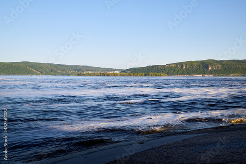 Nature landscape with beautiful water. Sea, river, lake, reservoir with blue waves. White foam on the wave