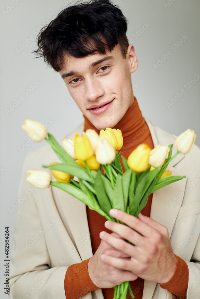 portrait of a young man bouquet of flowers romance fashion date isolated background unaltered