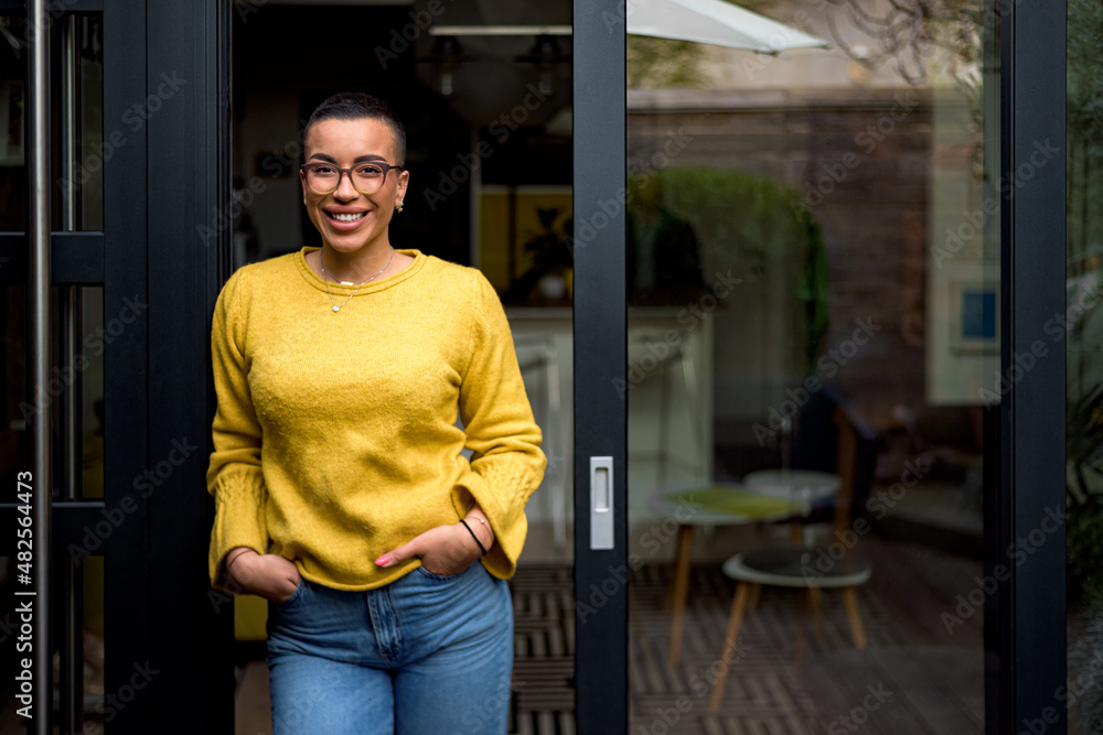 Fototapeta premium Cheerful happy satisfied smiling businesswoman or businessperson after a successful meeting. Adult person at the door of it's house looking at camera overwhelmed with success.