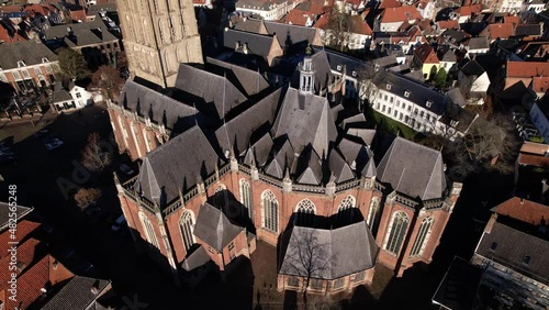 Top down aerial approach of steep slanted rooftops of Walburgiskerk church in picturesque tower town Zutphen in The Netherlands. Architectural detail of Dutch religious building photo