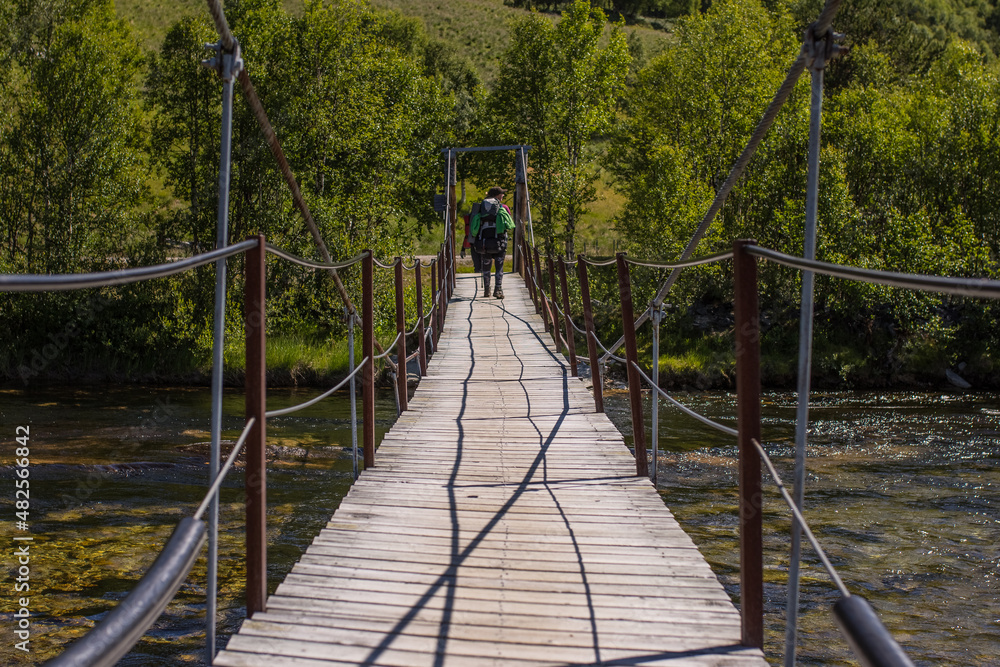 Footbridge across the river in Rondane National Park in Norway - the oldest national park in Norway with 10 peaks above 2,000 metres. Footbridge across the river in Rondane National Park in Norway - the oldest national park in Norway with 10 peaks above 2,000 metres.