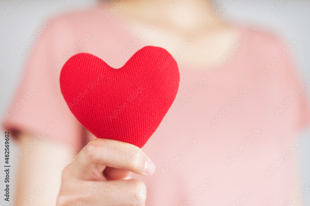 Woman holding red heart, love, health insurance, donation, happy charity volunteer, world mental health day, world heart day, valentine's day Woman holding red heart, love, health insurance, donation, happy charity volunteer, world mental health day, world heart day, valentine's day