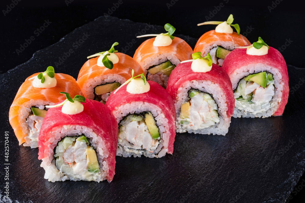 Set fresh delicious Japanese sushi on dark background Set fresh delicious Japanese sushi on dark background